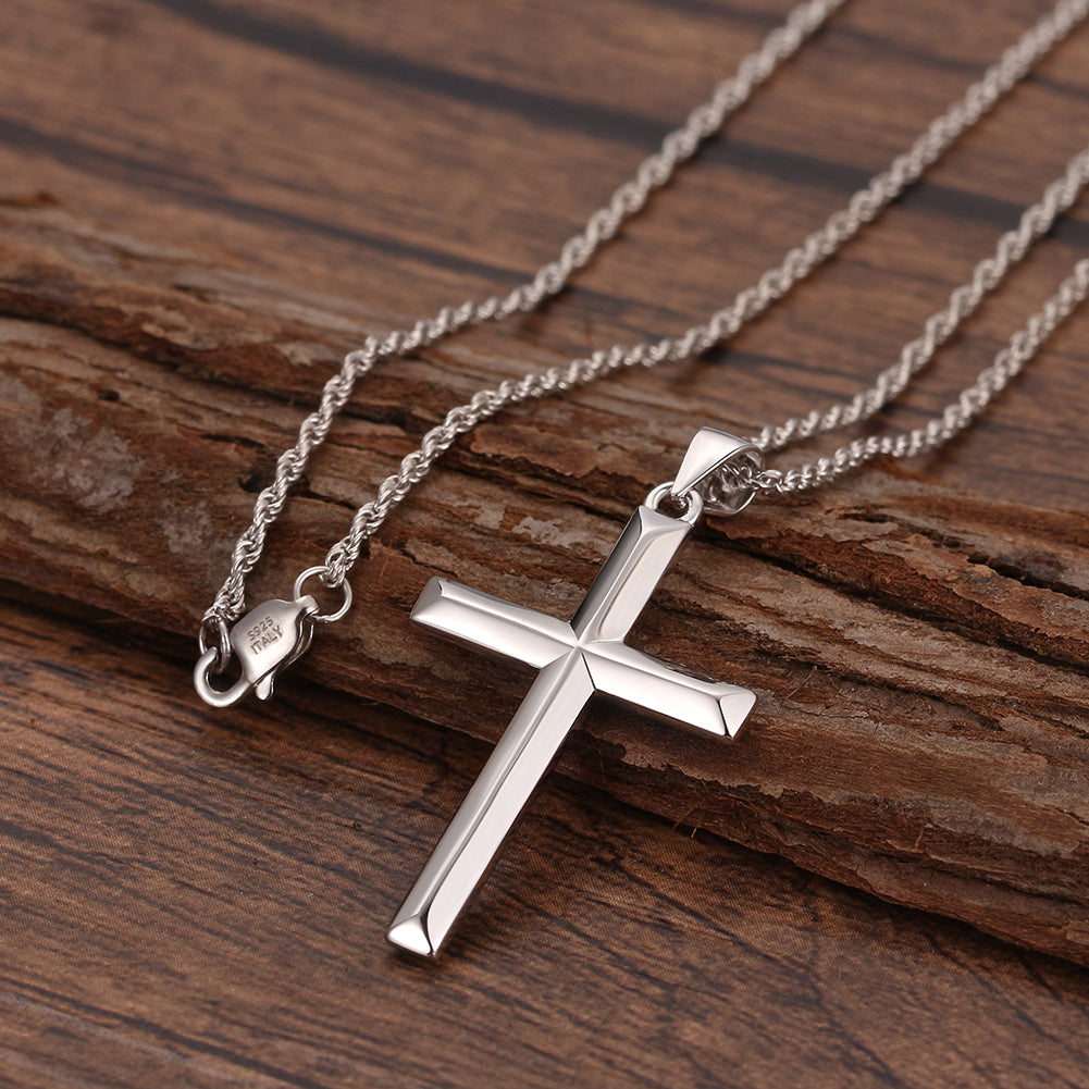 Silver cross necklace on a wooden surface