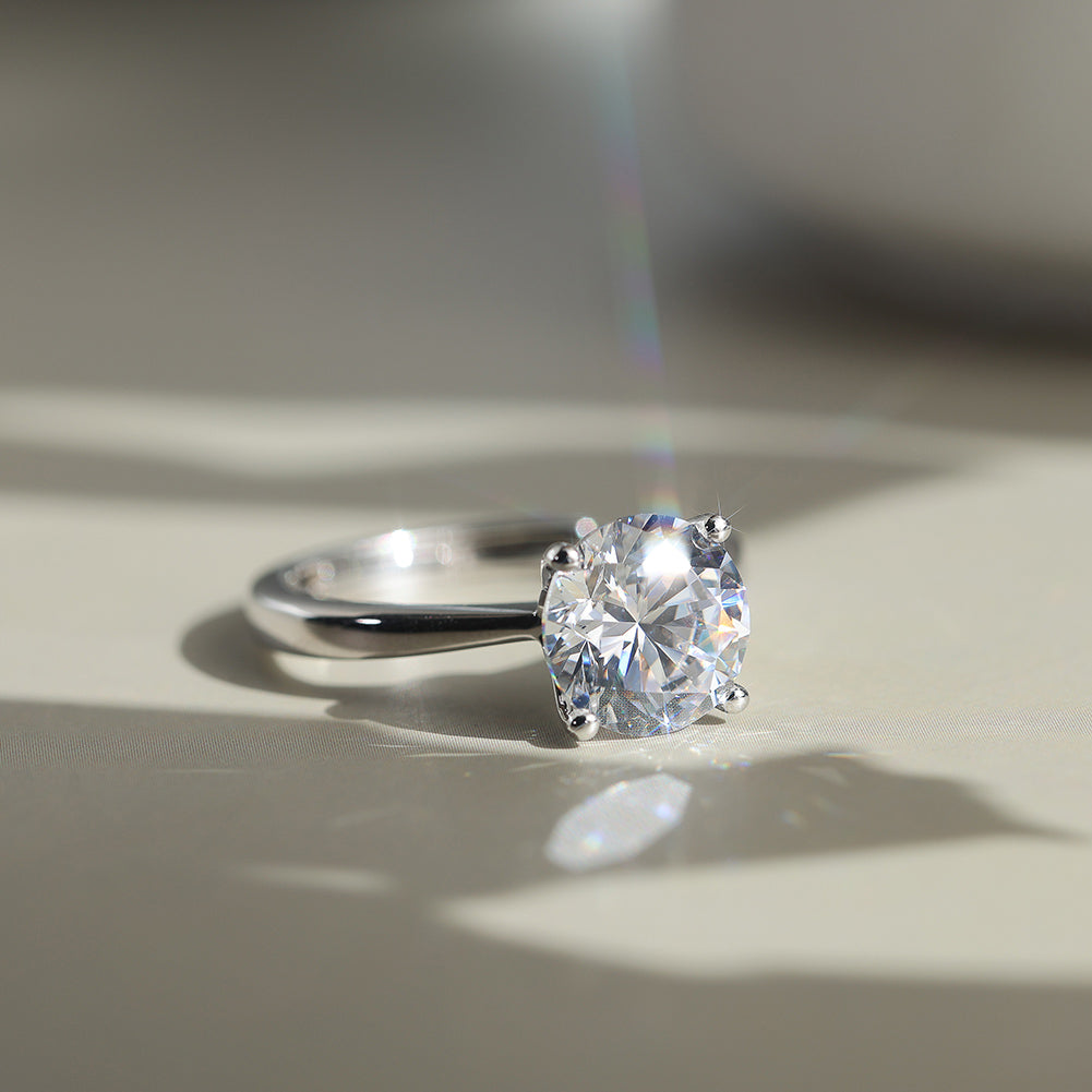 Diamond CZ ring on a light wooden surface with soft shadows