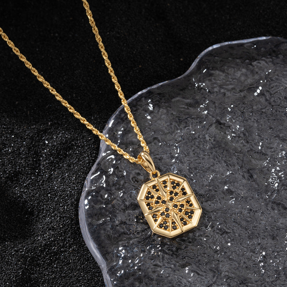 Gold necklace with a geometric pendant on a dark textured surface