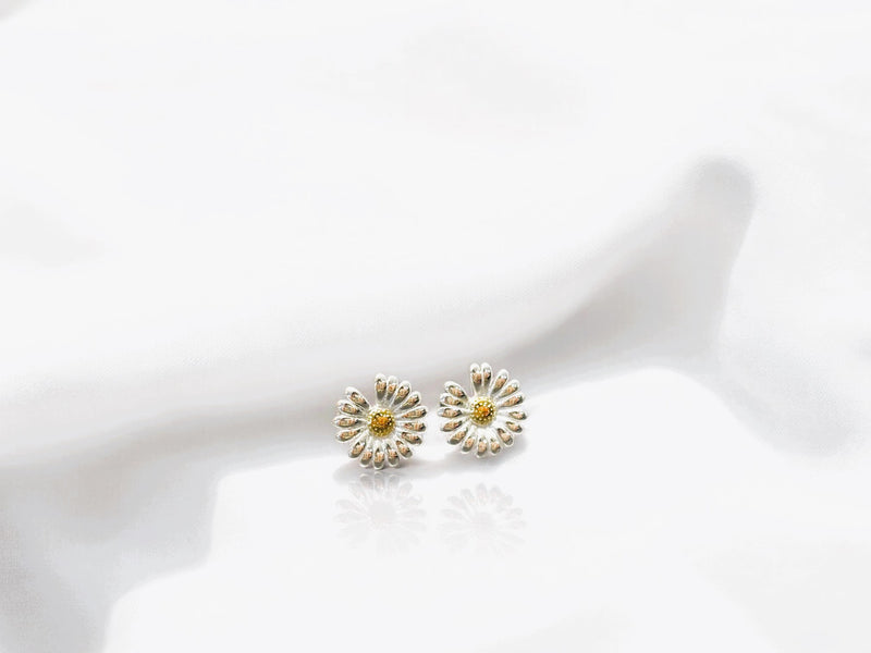 Flower shaped stud earrings on a white background