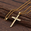 Gold cross necklace on a wooden surface