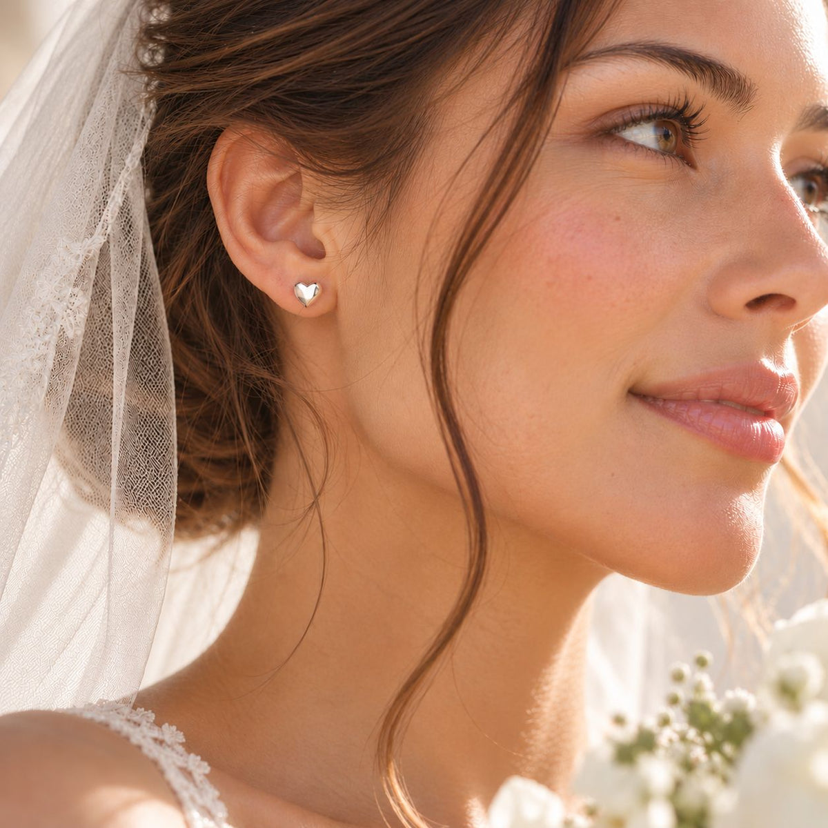 bride wearing simple classic sterling silver heart stud