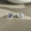 Pair of diamond CZ stud earrings on a neutral background
