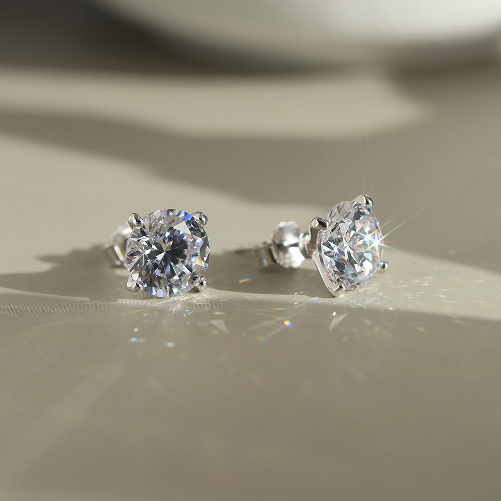 Pair of diamond CZ stud earrings on a neutral background