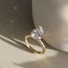 Gold ring with a diamond CZ on a neutral background