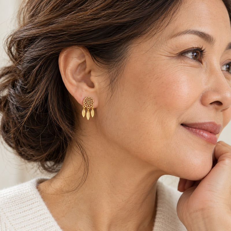 Model wearing a gold plated sterling silver dream catcher earrings