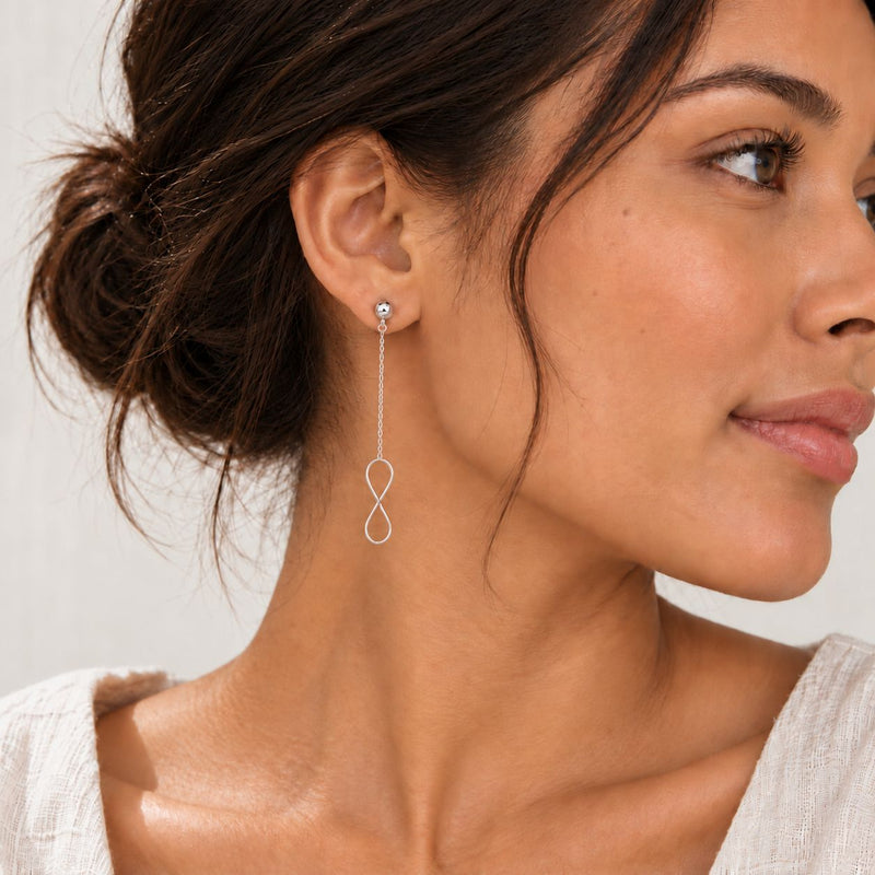 sterling silver infinity dangle earrings worn by a model