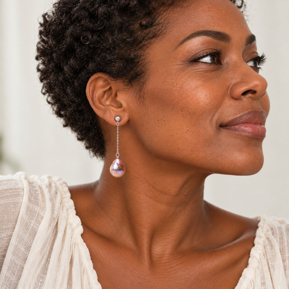model wearing baroque purple pearl earrings 