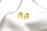A pair of gold-colored butterfly earrings with a vermeil coating on a white background