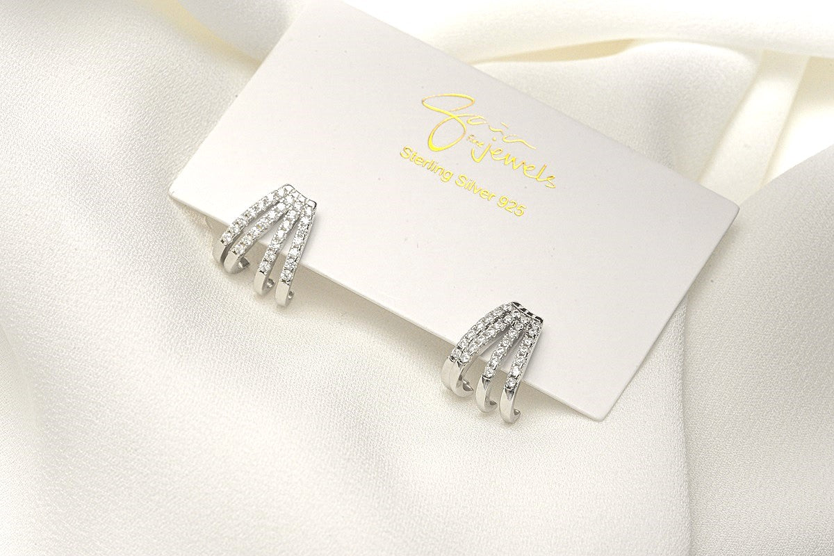 A pair of silver-colored butterfly earrings with a vermeil coating on a white display card with a white background