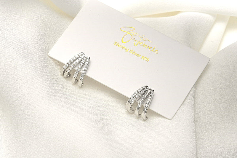 A pair of silver-colored butterfly earrings with a vermeil coating on a white display card with a white background