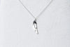 A sterling silver necklace with a pendant feather charm, displayed against a white background.
