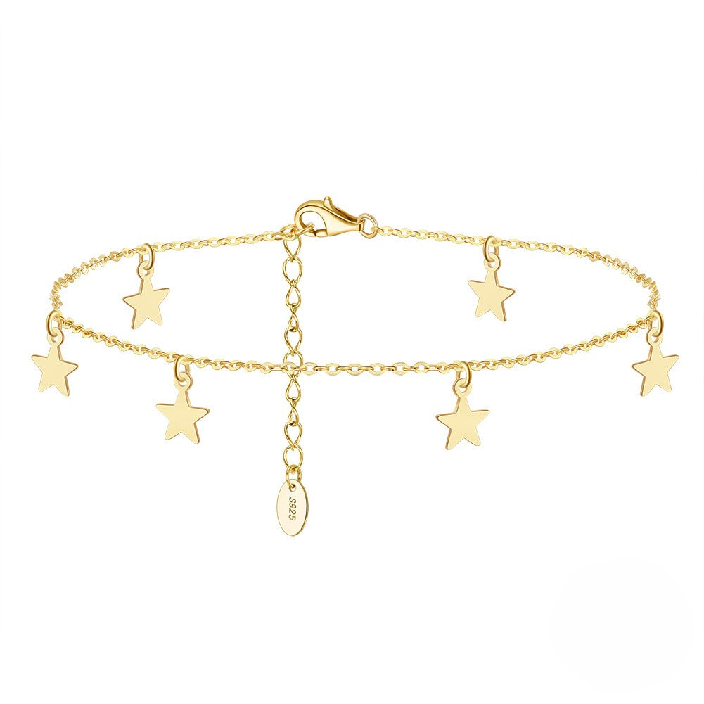 A gold-colored sterling silver anklet with star charms and a Vermeil coating.