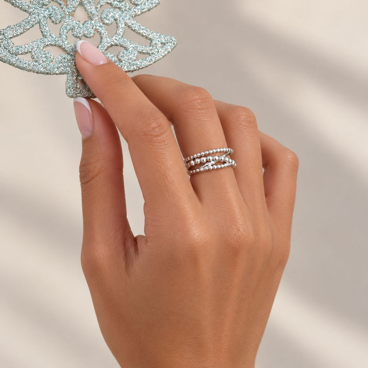 model's hand wearing sterling silver of water layer ring