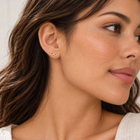 Gold Infinity Earrings Sterling Silver Stud worn by a model