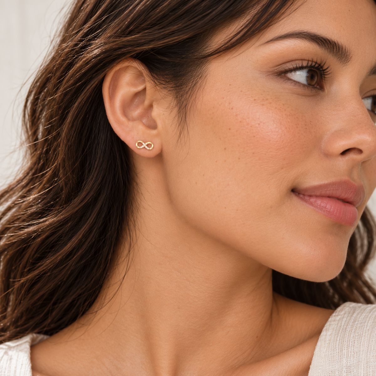 Gold Infinity Earrings Sterling Silver Stud worn by a model