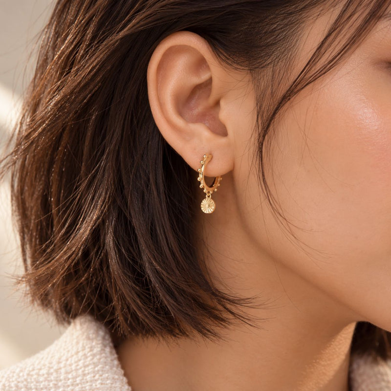 model's ear wearing huggies gold vermeil