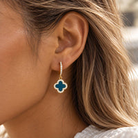 Teal Blue Clover Huggies on model's ear