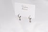 A pair of sterling silver hoop earrings with a floral detail, displayed on a white card with the brand name 'Gaia'.