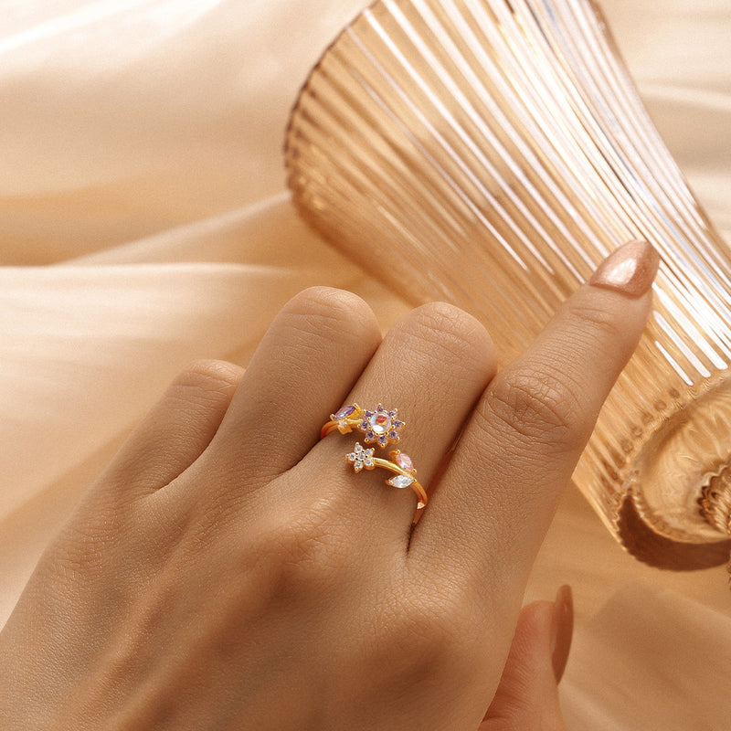 Hand wearing a decorative ring on a soft fabric background