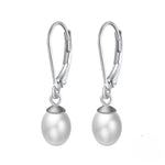 Load image into Gallery viewer, A pair of silver leverback pearl earrings on a white background.

