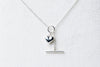 A sterling silver necklace with a small heart pendant, on a white background.