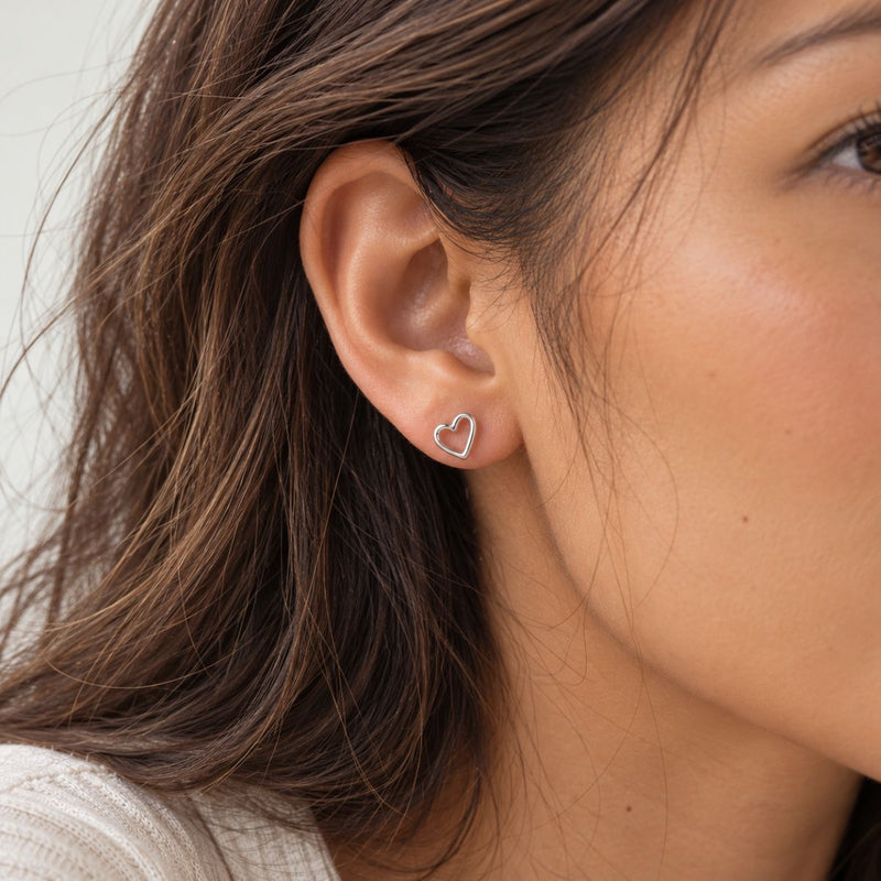 woman ear wearing skinny love silver stud
