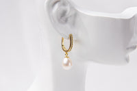 A gold vermeil earring with a pearl displayed on a white mannequin head