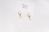 A pair of gold vermeil earings with cuic zirconias and champagne pearls on a white display card and white background