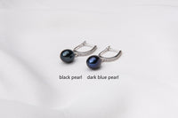 Two pearl earrings featuring silver. One has a black pearl, one has a dark blue pearl. On a white background with labelling for each different color.