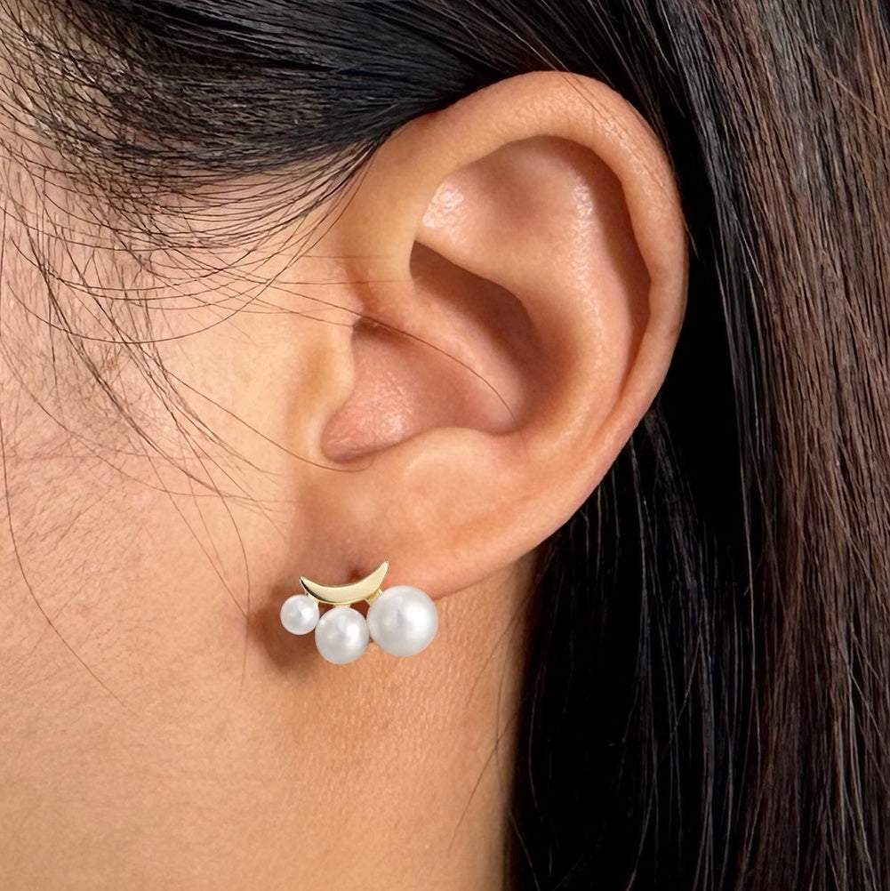 Pearl and gold vermeil earring worn on an ear