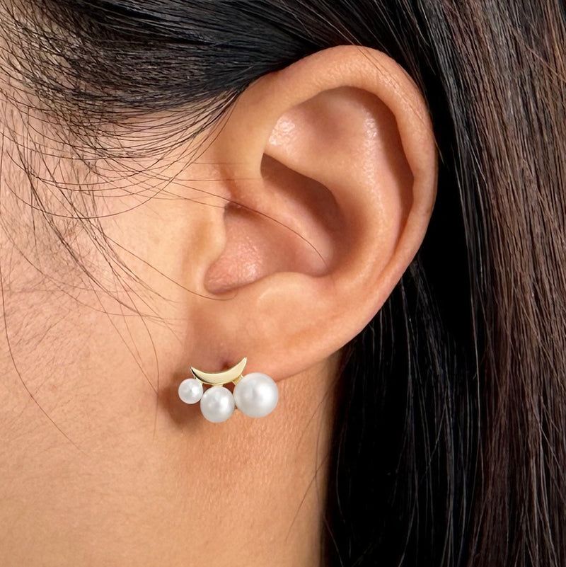 Pearl and gold vermeil earring worn on an ear