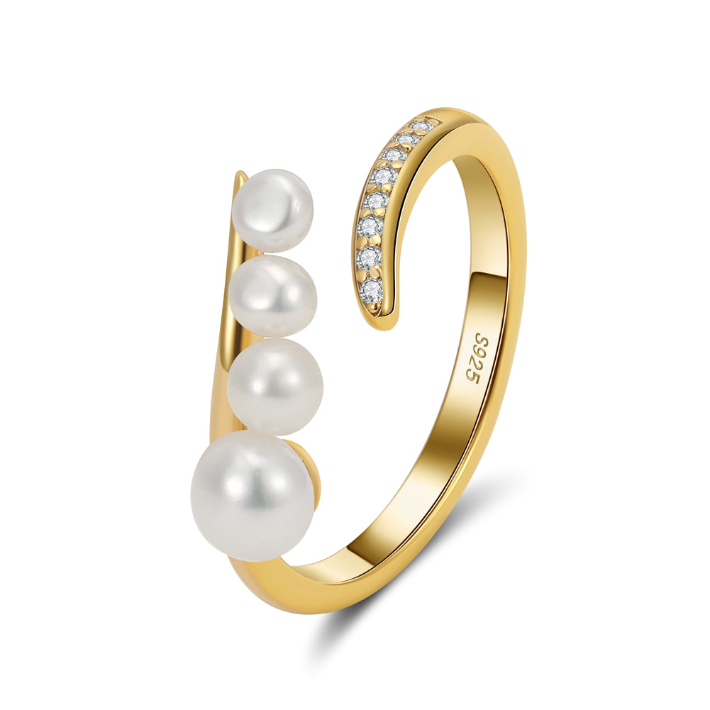 Gold ring with pearls and cubic zirconias on a white background