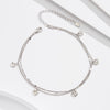 Silver anklet featuring small round pendants