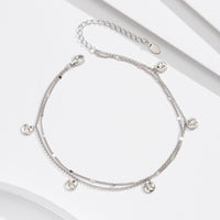 Silver anklet featuring small round pendants
