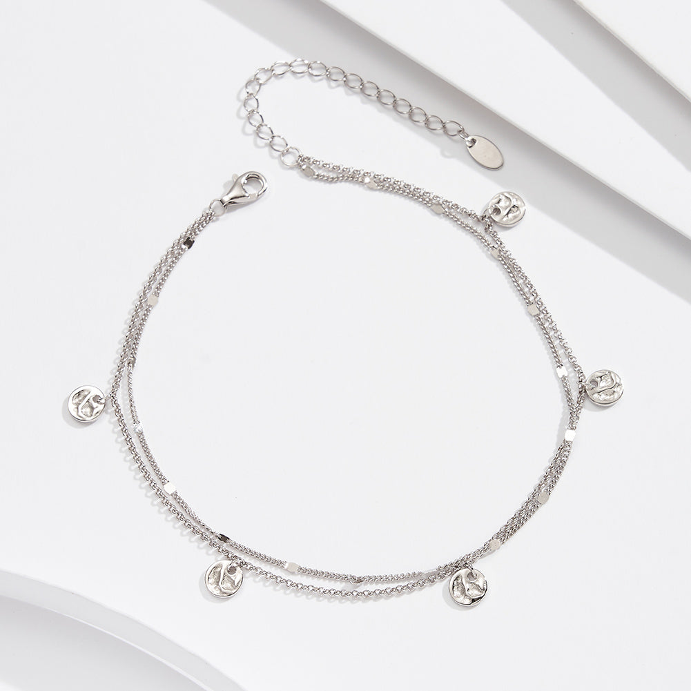 Silver anklet featuring small round pendants