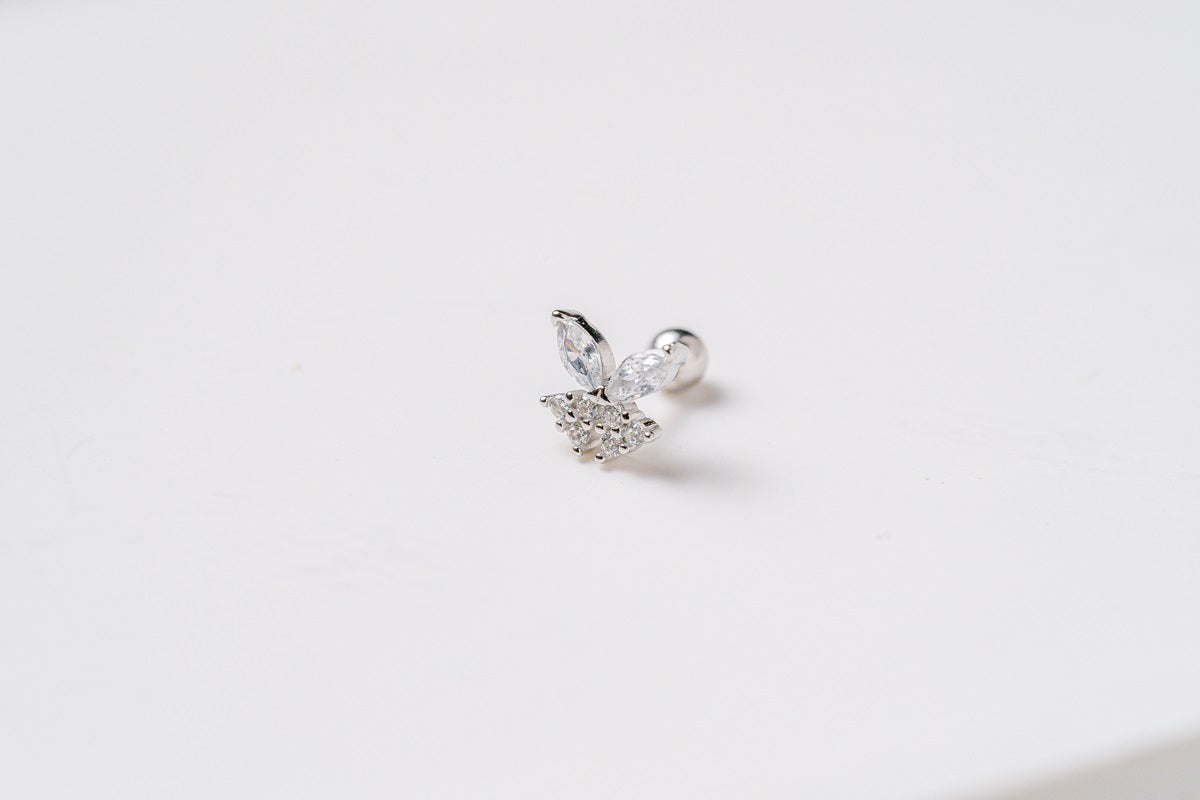 A silver fairy shaped earring featuring cubic zirconias on a white background