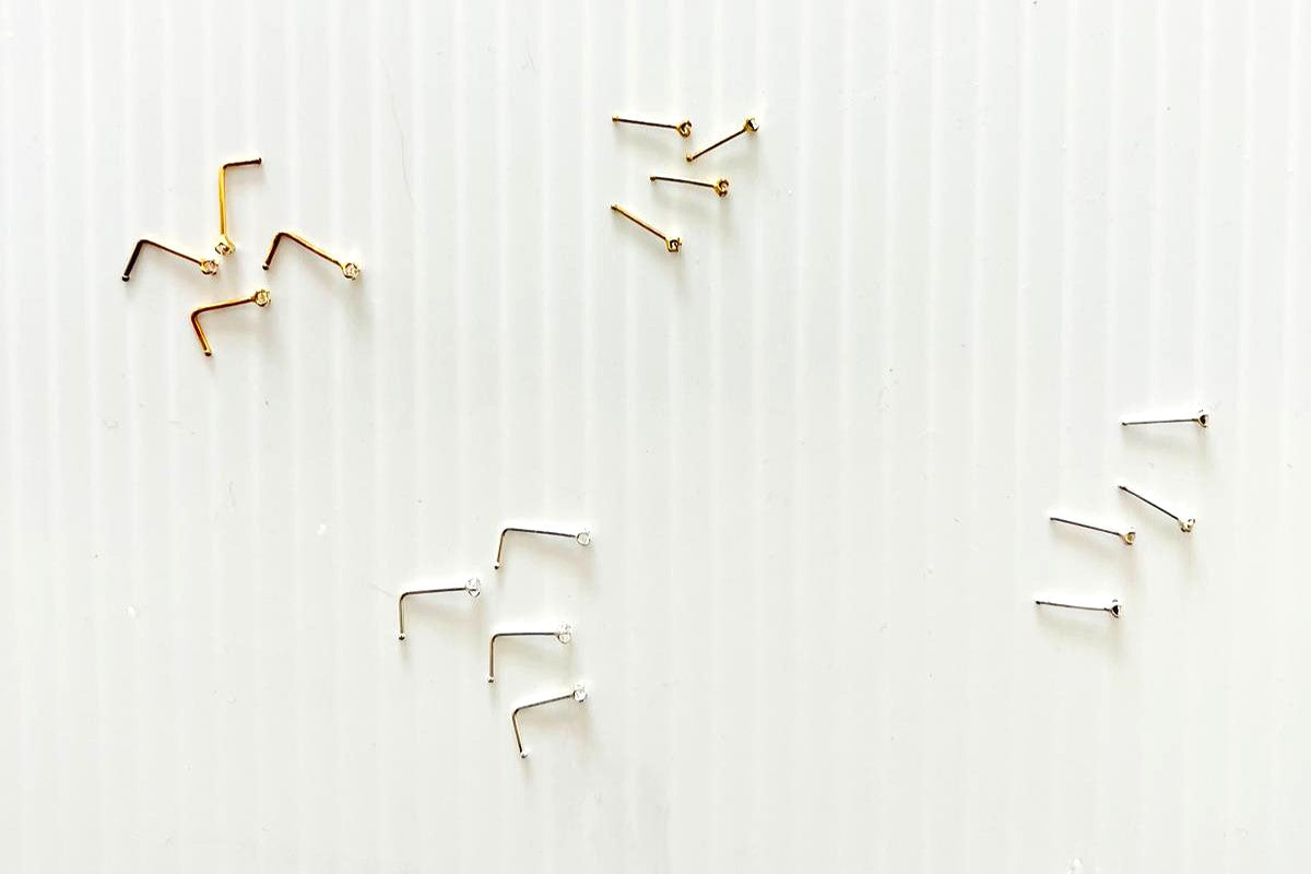 Various nose studs on a white background