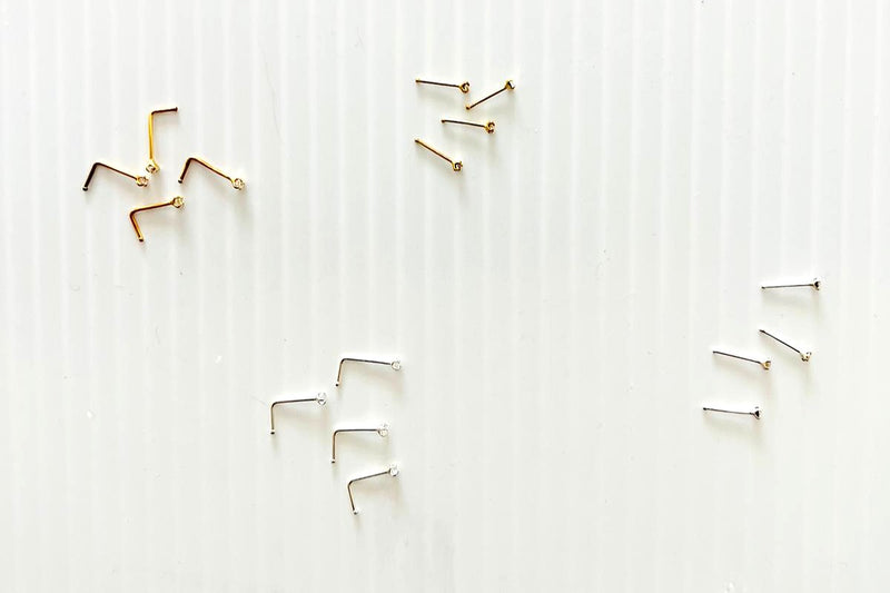Various nose studs on a white background
