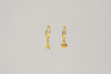 A pair of gold vermeil hoop earrings with a starfish and shell dangle, displayed against a plain background.