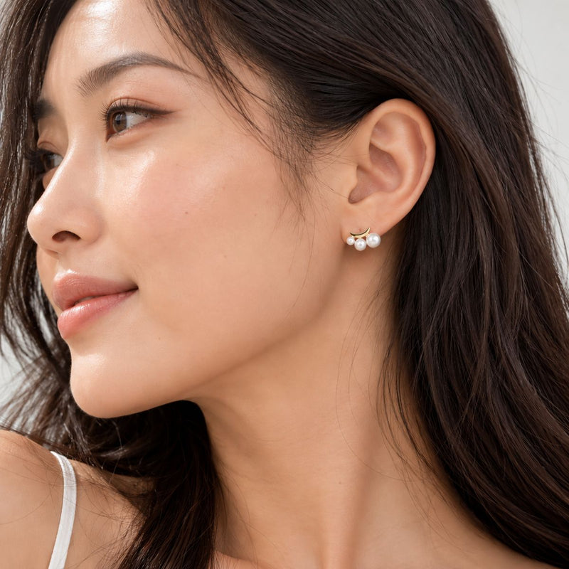 oriental looking model wearing luna crescent pearl earrings