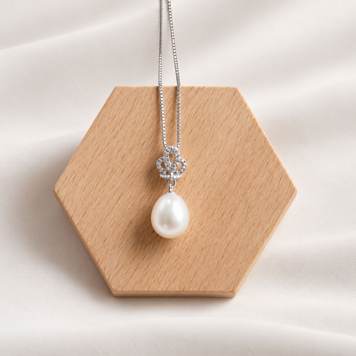 crown necklace on wood display 