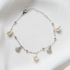 A sterling silver bracelet with freshwater pearl and shell-shaped silver elements