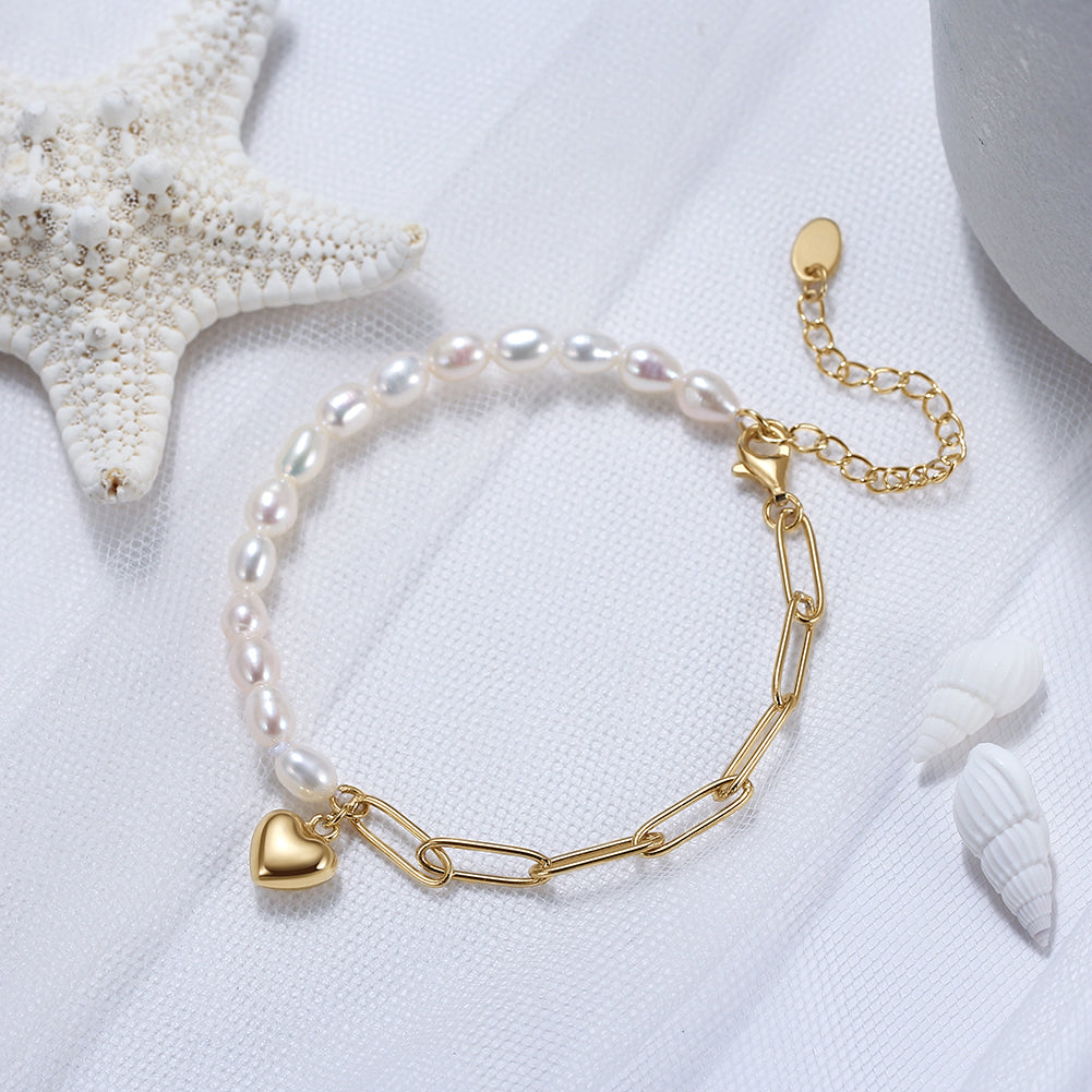 Pearl bracelet with a gold heart charm on a white background