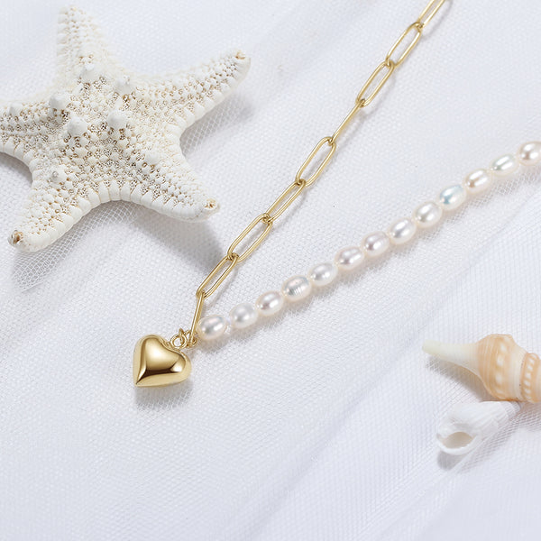 Pearl necklace gold vermeil with a gold heart pendant on a white background 
