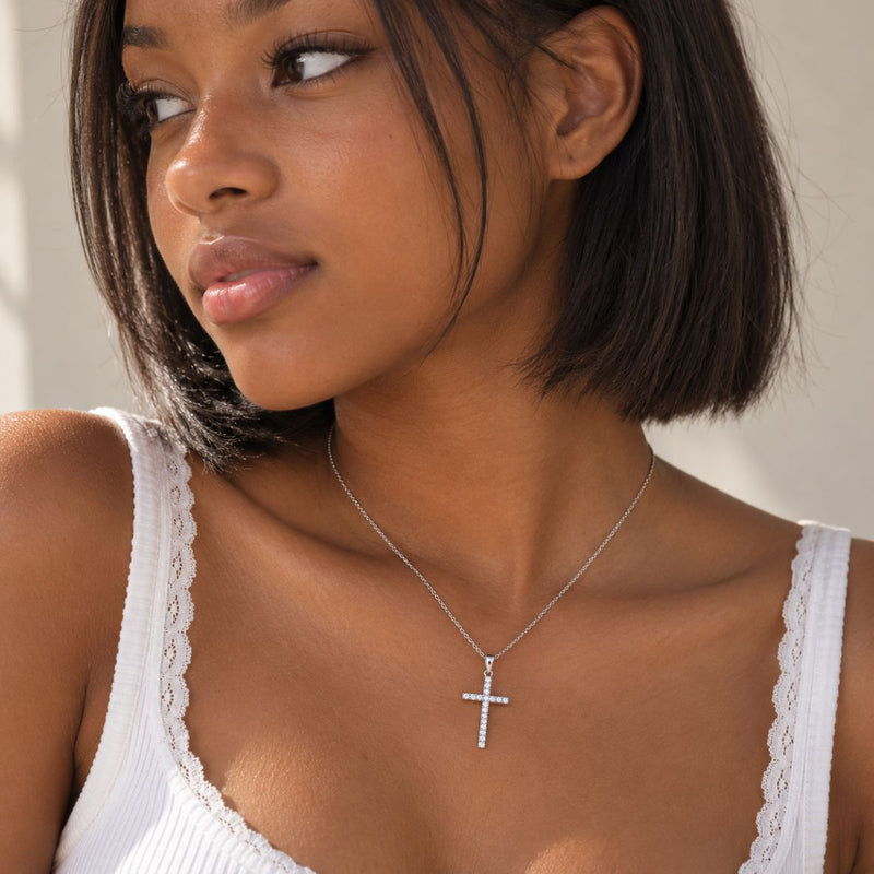teenager wearing cross diamond necklace