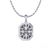 Silver pendant with black stones on a white background