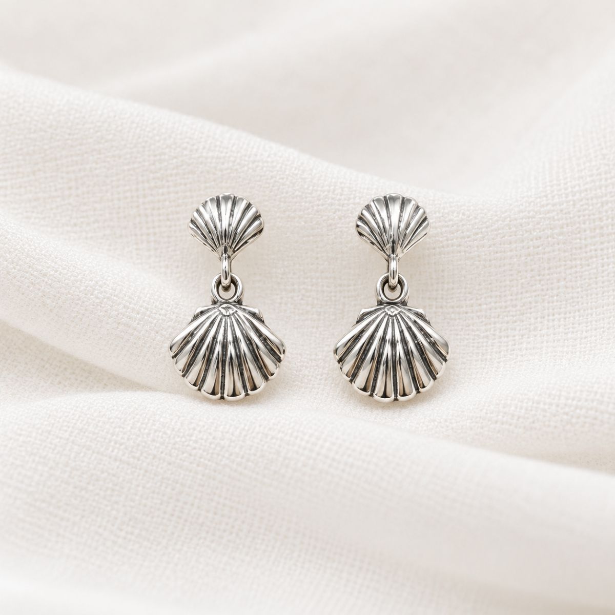 SilverShellEarringsonDrapedLinen 