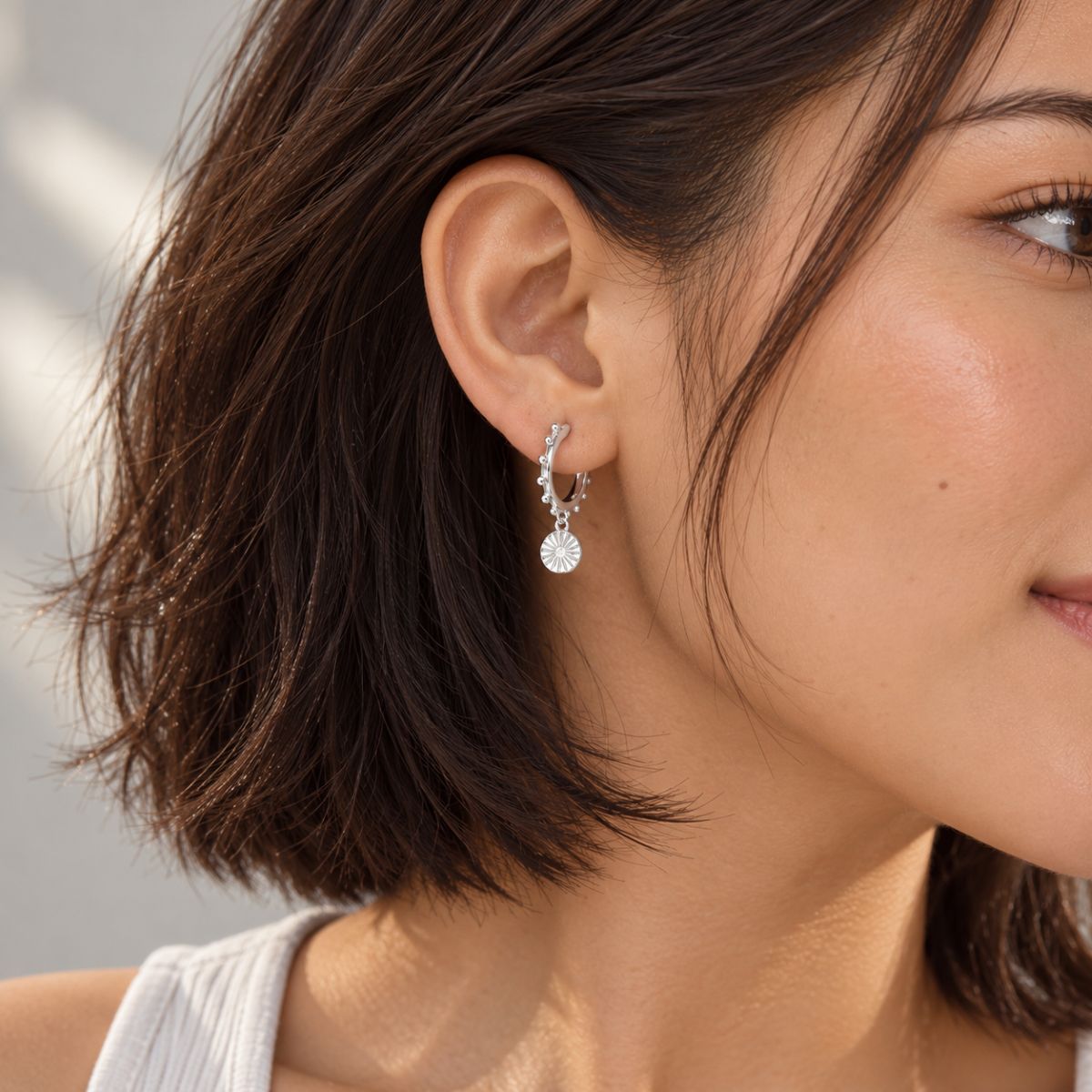 model's ear wearing huggies sterling silver
