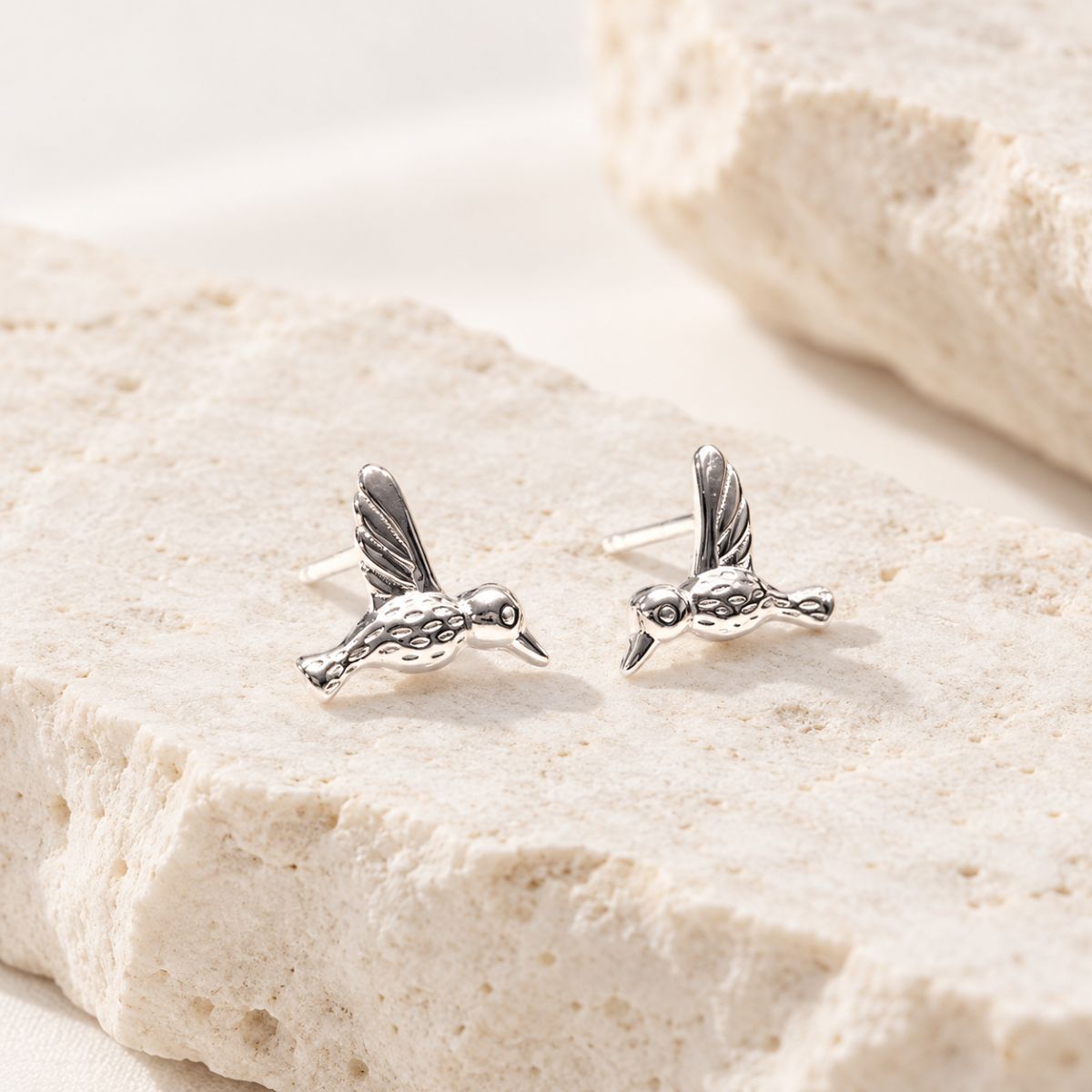 Silver Humming bird Stud Earrings on Stone
